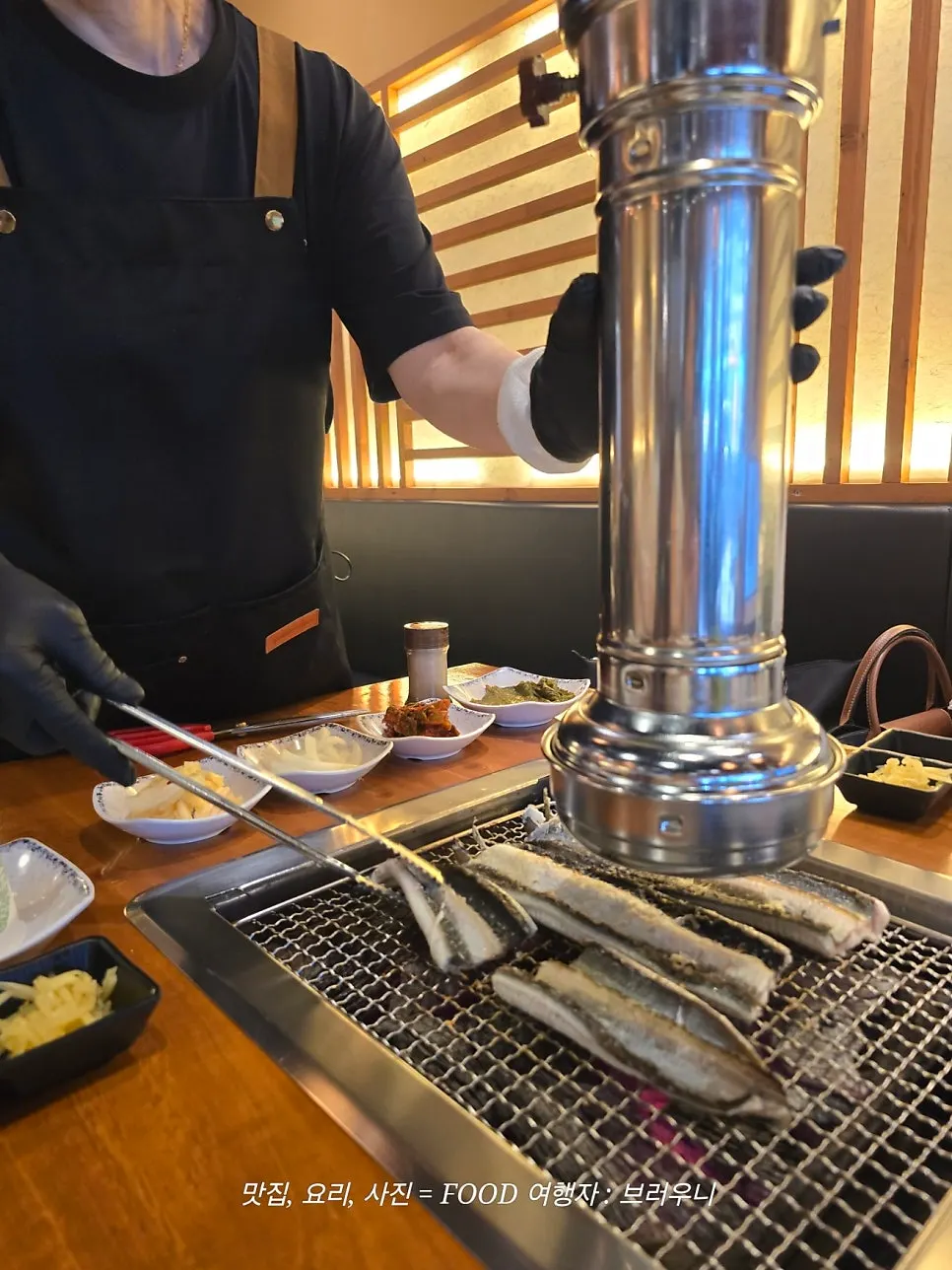 Three family members seated at a grilled eel table