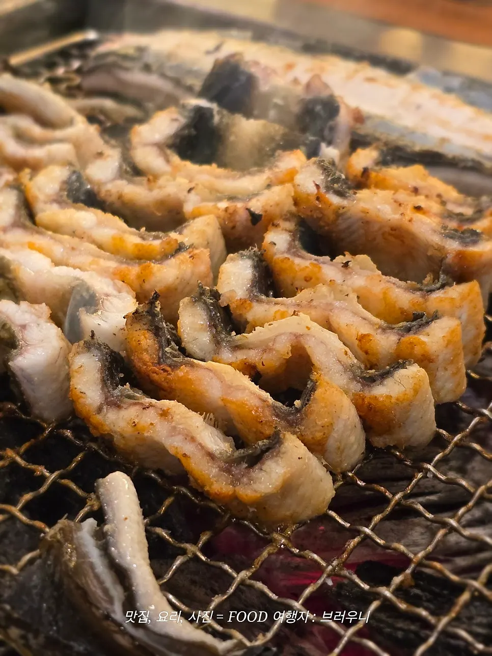 Table set with grilled eel and side dishes