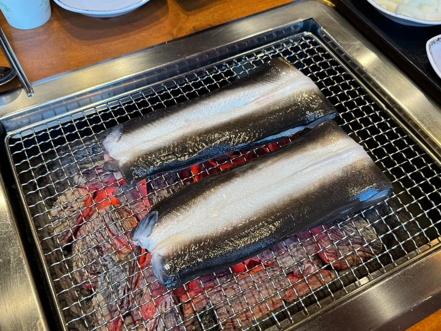 Freshwater eel grilling on a charcoal grill