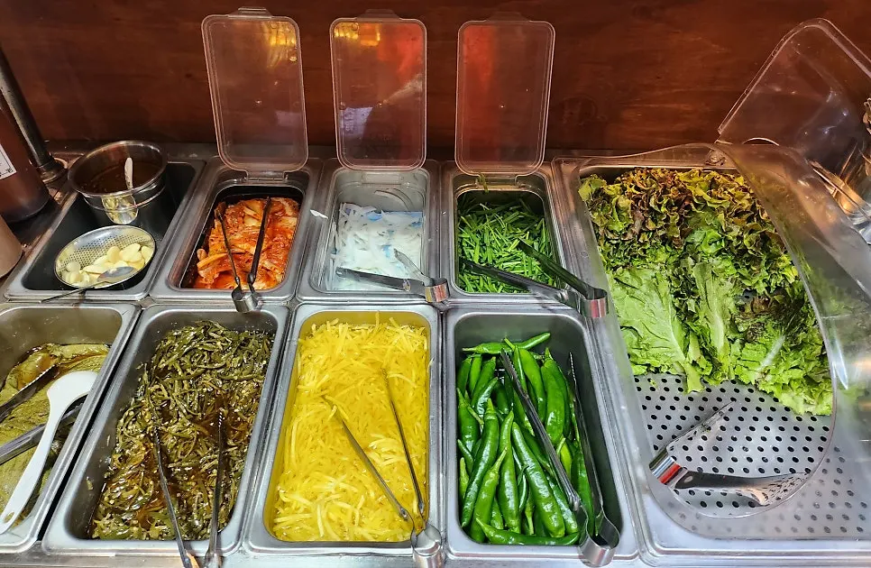 Self-serve bar for side dishes on one side of the hall
