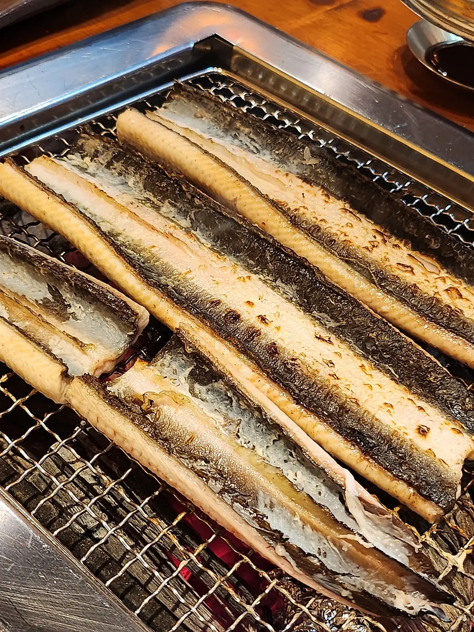 Grill grate over the heated charcoal