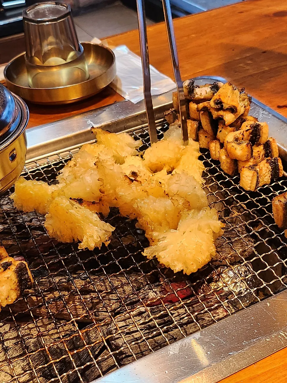 Snow mushroom grilling at the edge of the grill