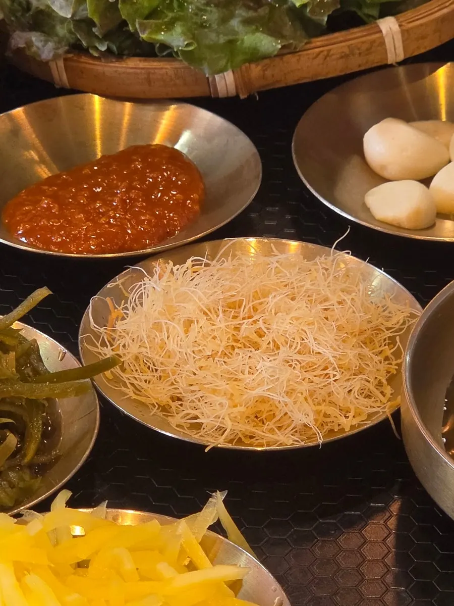 Full table spread of side dishes served with the eel