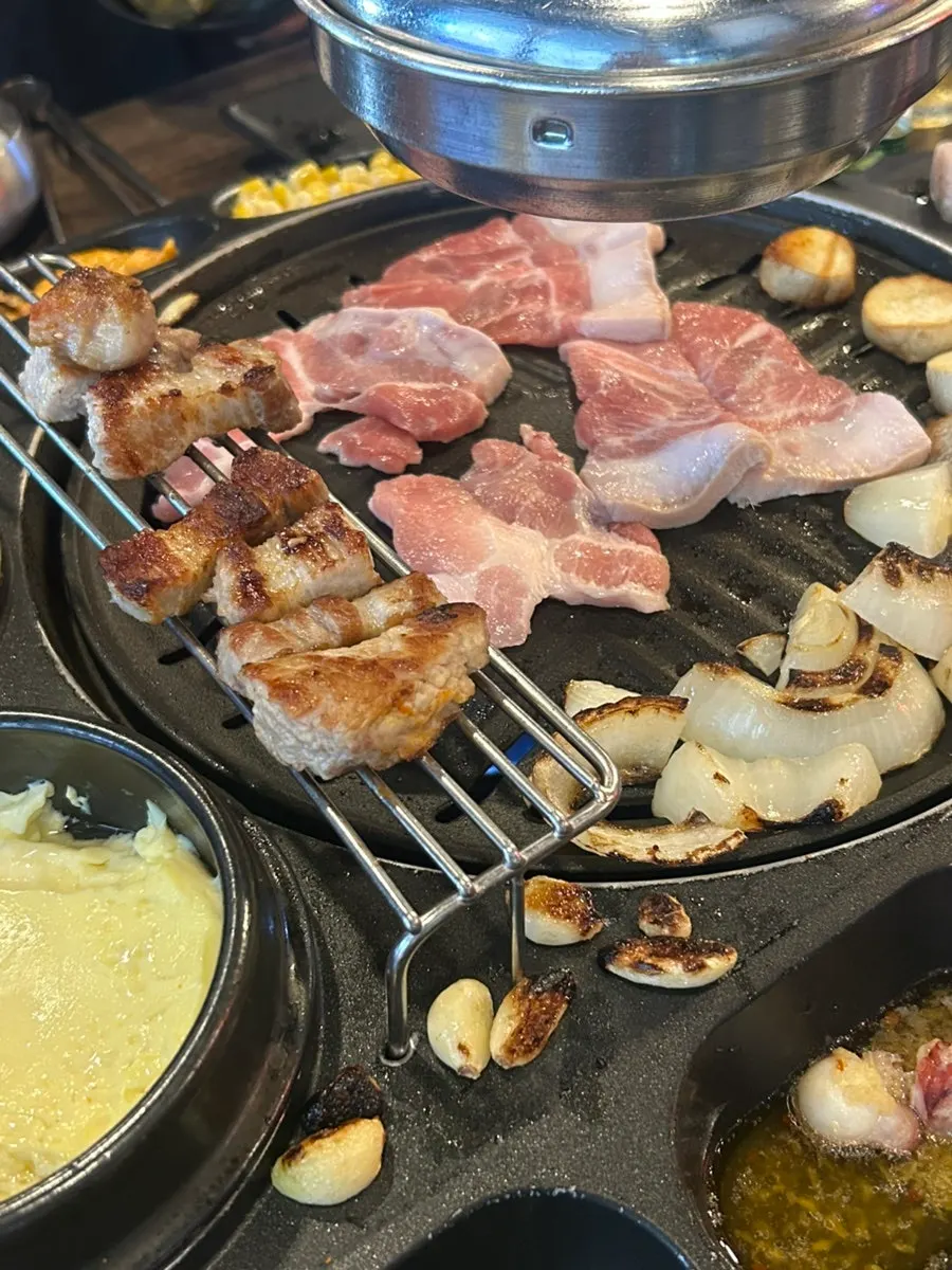 A bite of pork belly with grilled kimchi
