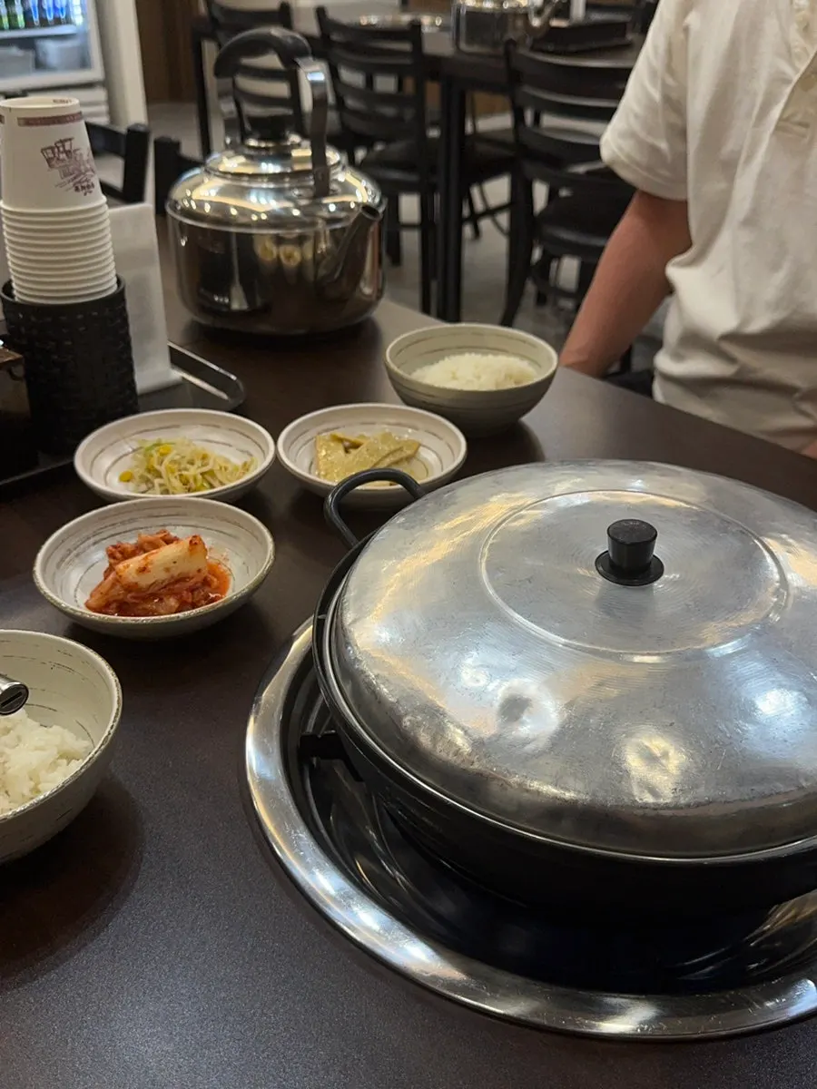 Three side dishes: braised fish cake, seasoned bean sprouts, and kimchi