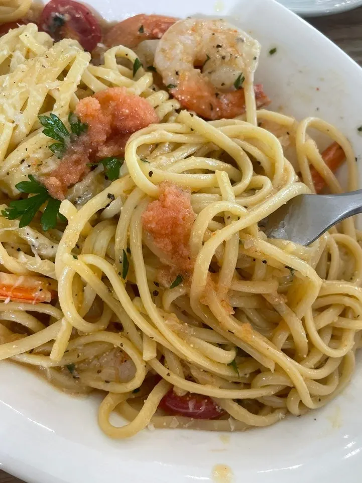 Close-up of oil pasta topped with mentaiko