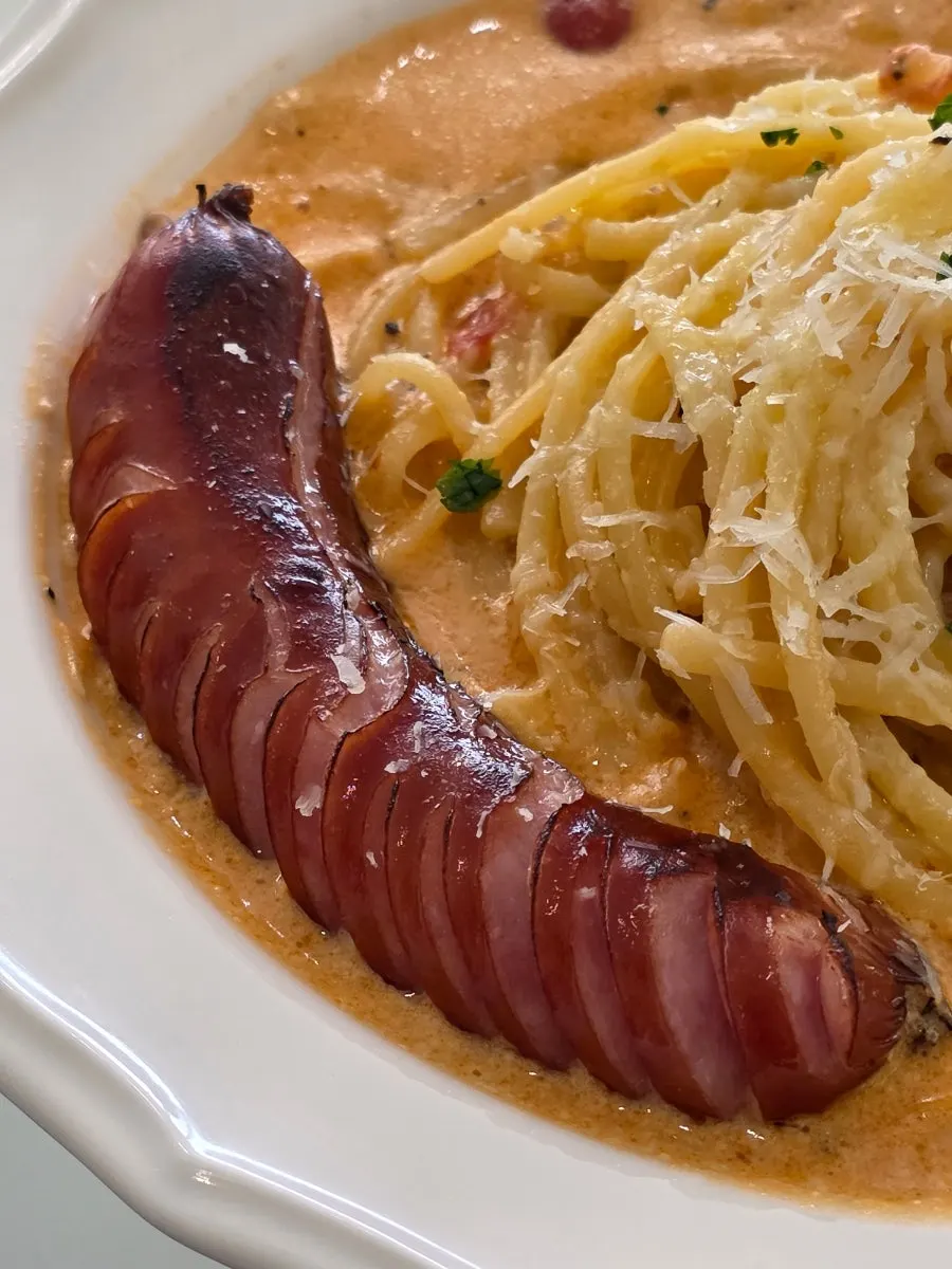Two plates of pasta set on the table