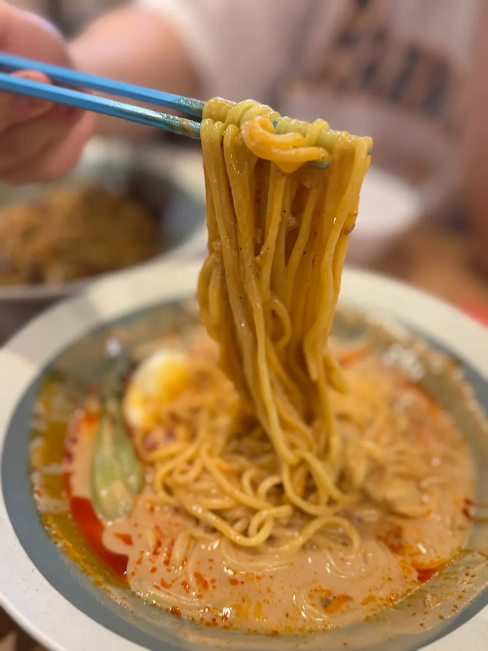 Spoon scooping up tantanmen broth