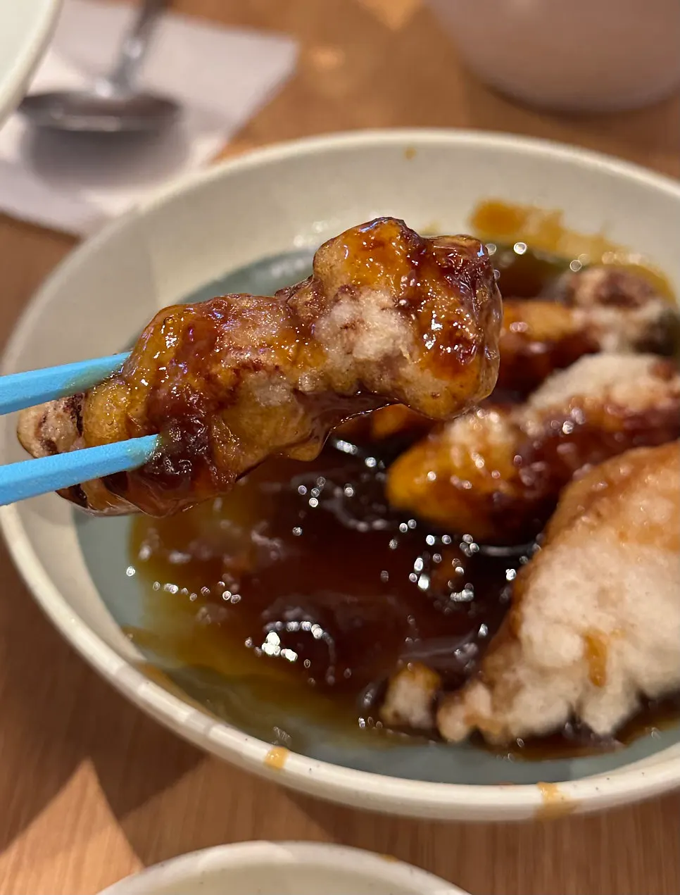Cross-section of thick tangsuyuk meat dipped in sauce