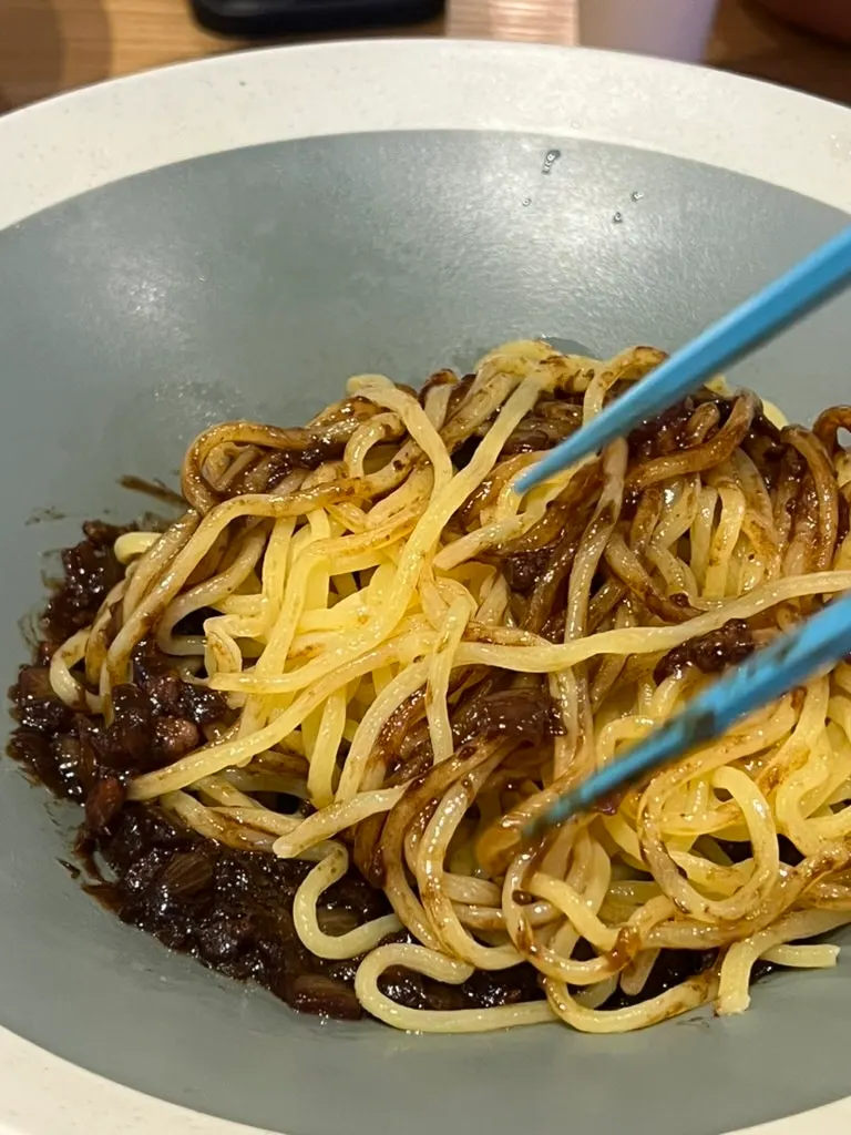 Vertical photo of jjajangmyeon before mixing