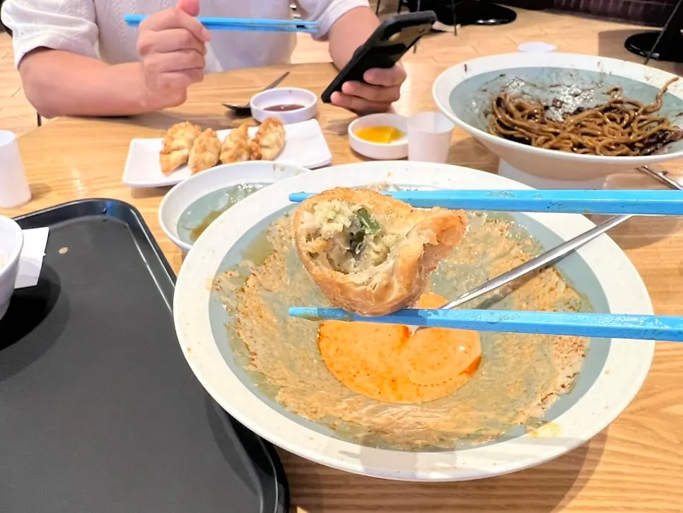 Dumpling dipped in tangsuyuk sauce