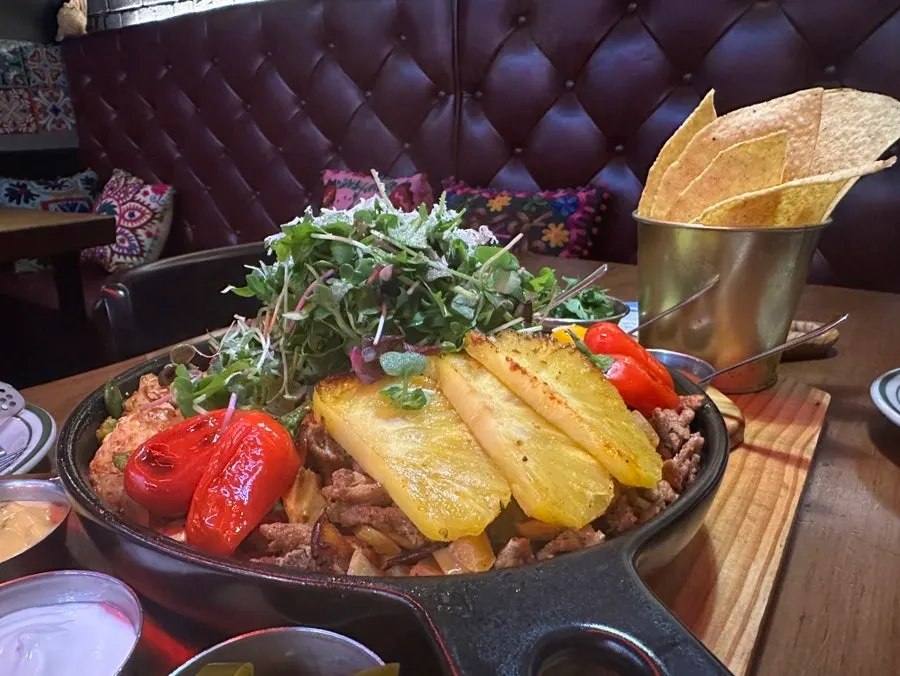 Taco ingredients served hot on the cast-iron platter
