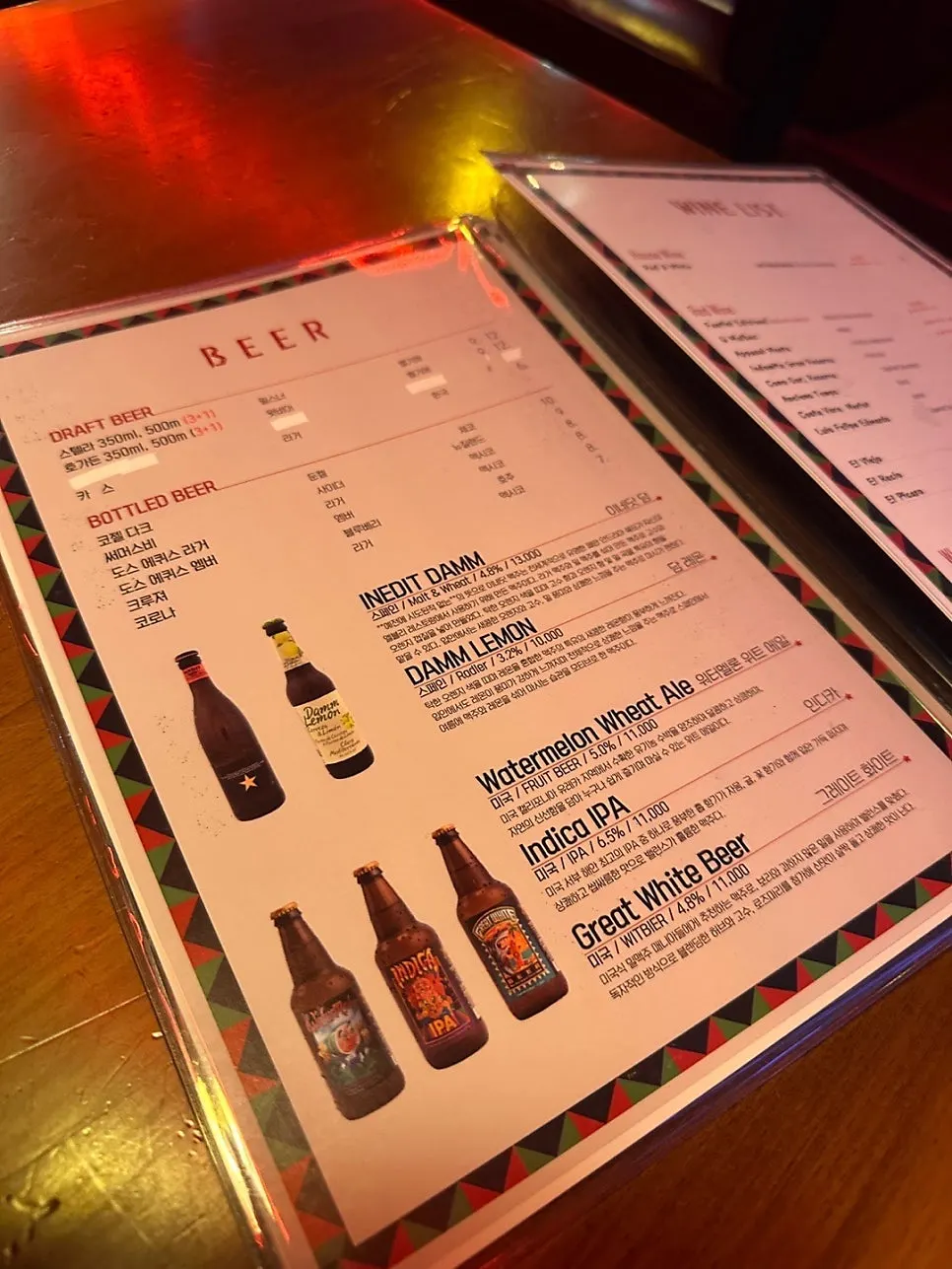 Menu listing beers and cocktails at Chilango