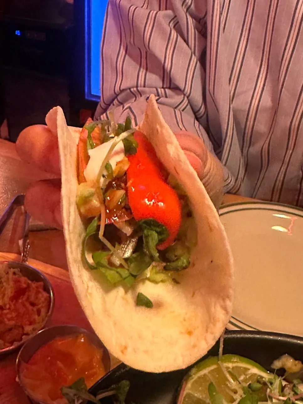 Close-up of a beef taco topped with sour cream