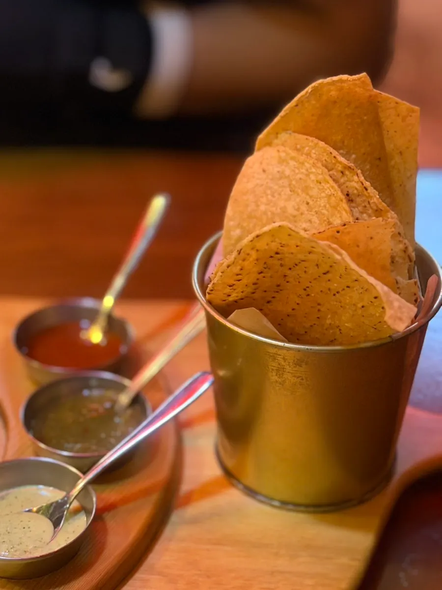 Side dish of sauces served with the tacos