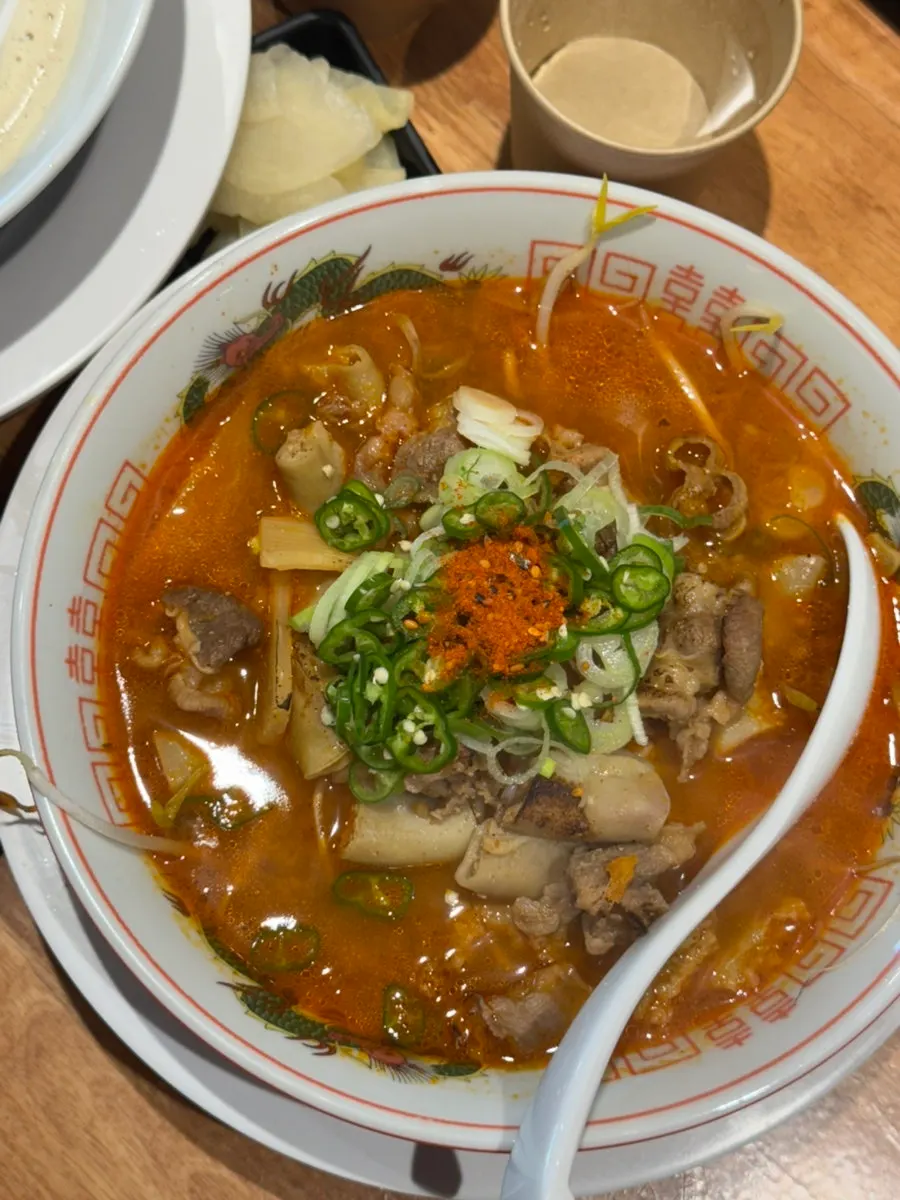A full spread of toripaitan, takoyaki, and motsu ramen
