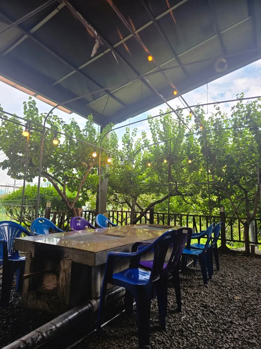 Lit-up outdoor seating area at Yaksamgol Garden