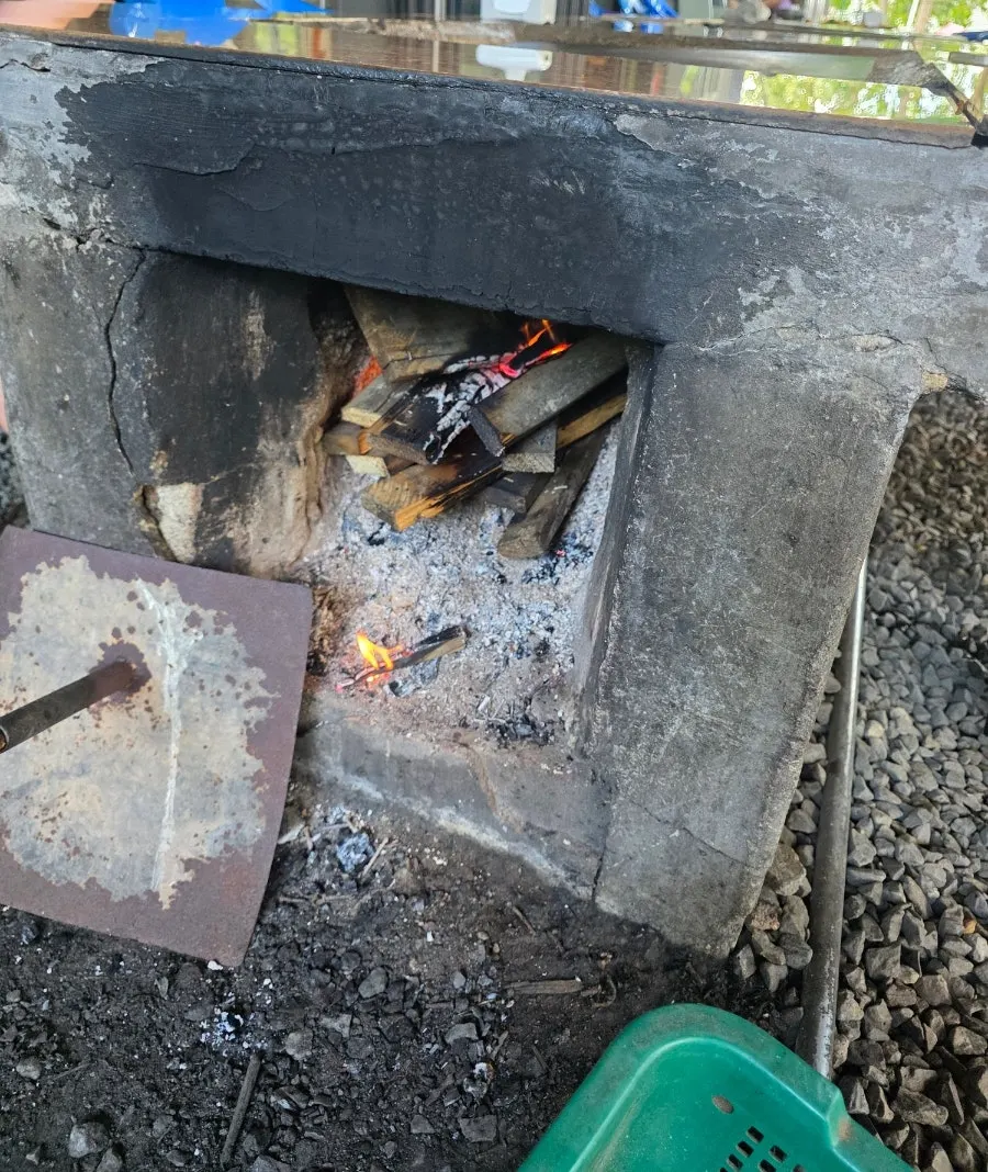 Wood fire burning beneath the stone plate