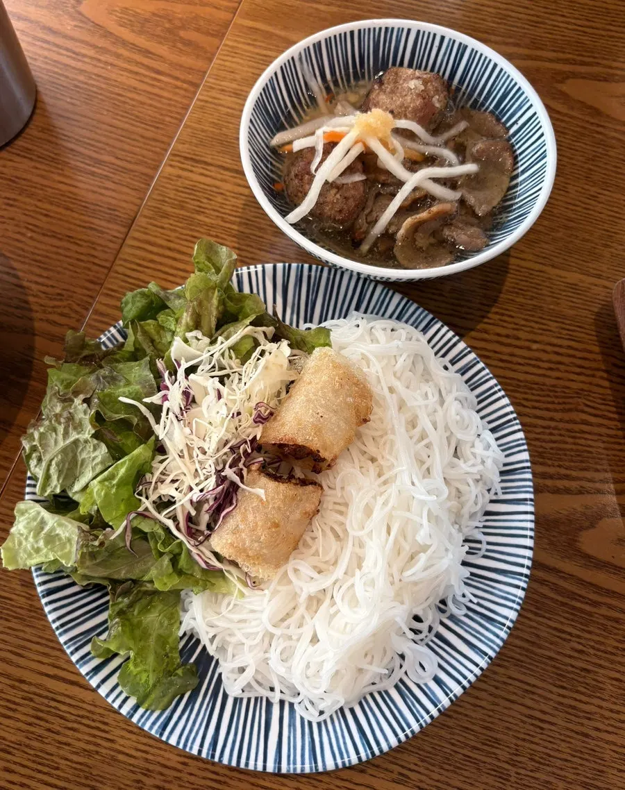 A spoonful of the rich pho broth