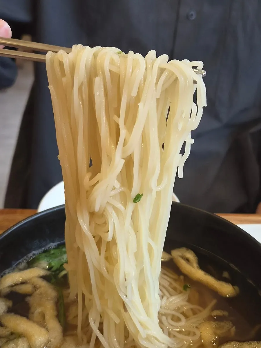 Fresh noodle strands in anchovy broth