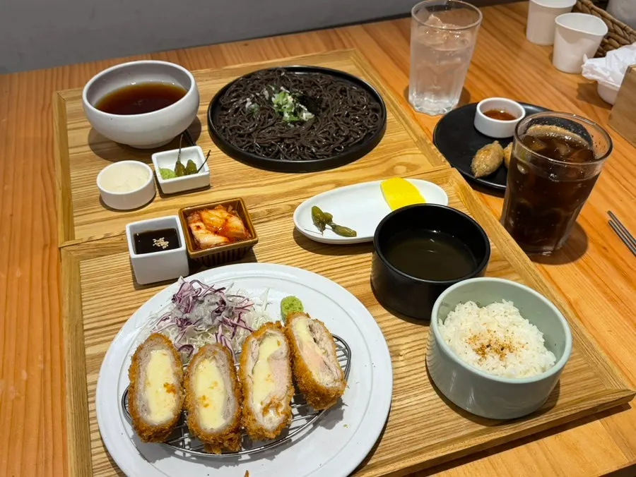 Full table with pork cutlet and noodle dishes together