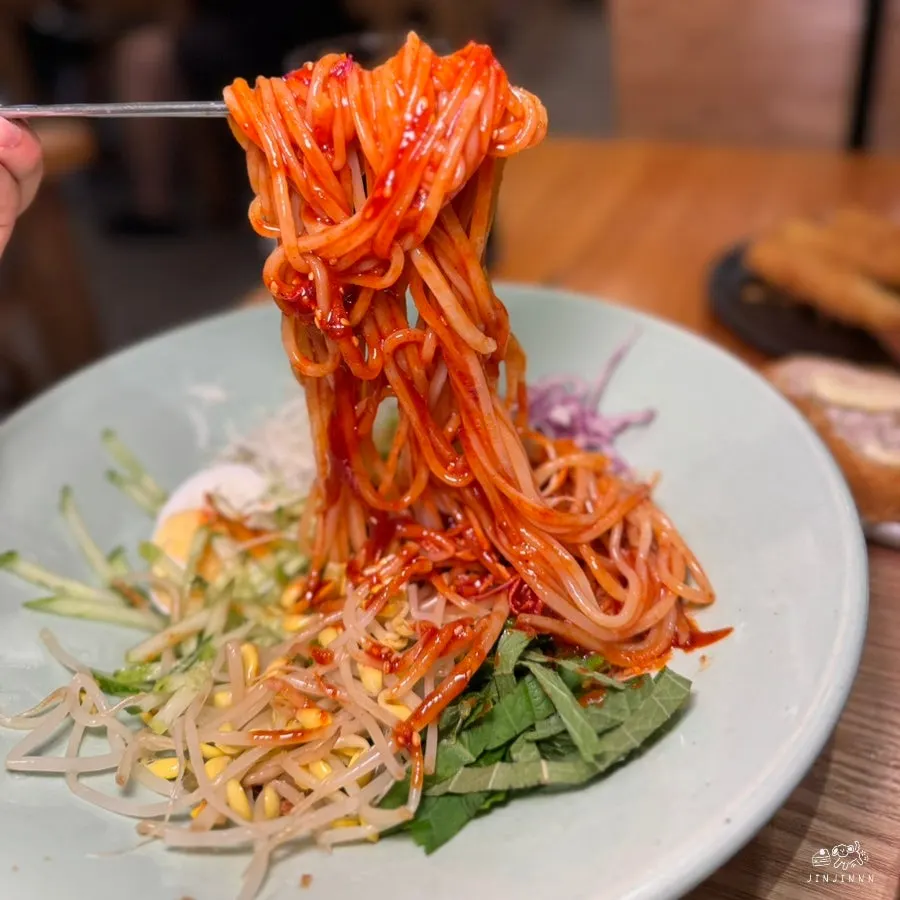 Close-up of the thick noodles in real cheese pork cutlet bibim jjolmyeon
