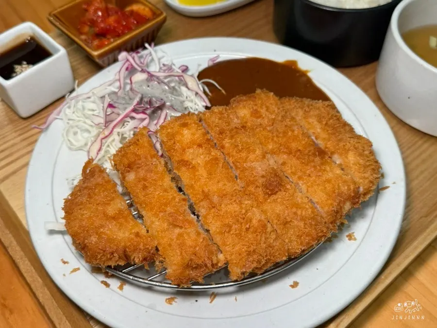 Cross-section of the whole sirloin pork cutlet showing its crispy batter