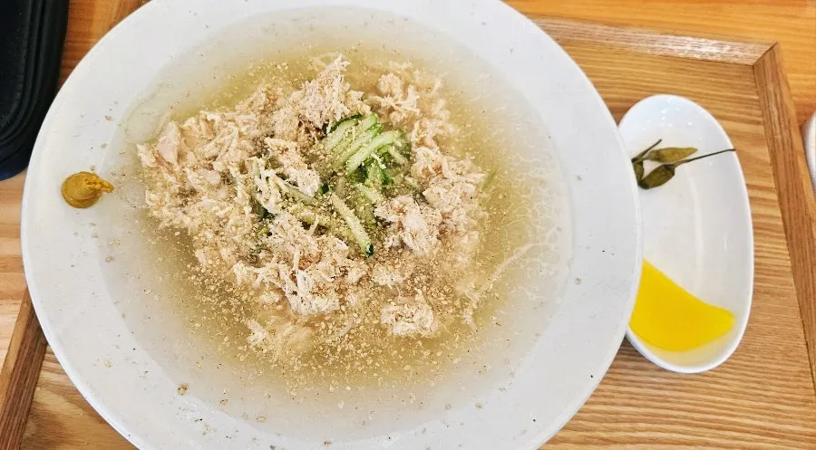 Bowl of chogye guksu topped with chicken breast