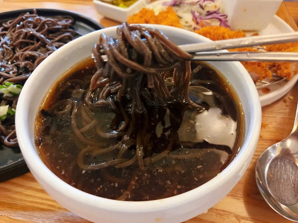 Buckwheat soba noodles dipped into the broth