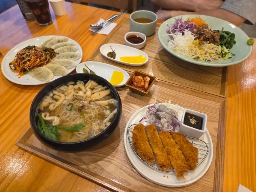 Table set with the fresh noodle set, bibimbap, and bibim mandu