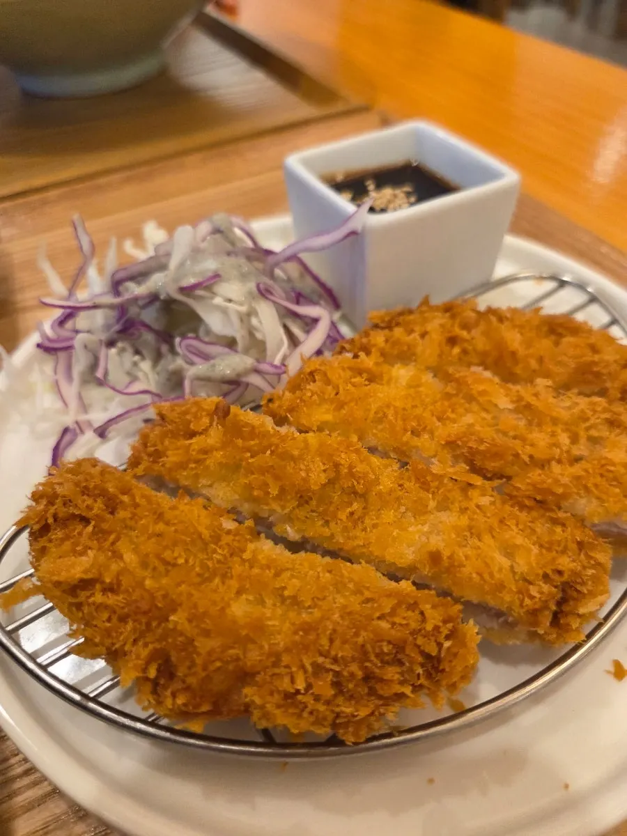 Thin fresh noodle strands lifted with chopsticks