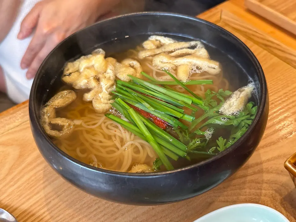 Spread of gukbap and noodle dishes on the table