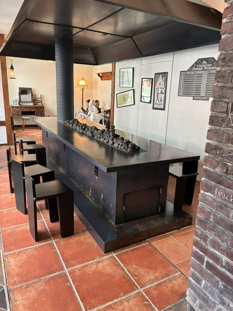Workspace where dough is wound onto wooden rods and baked into chimney bread