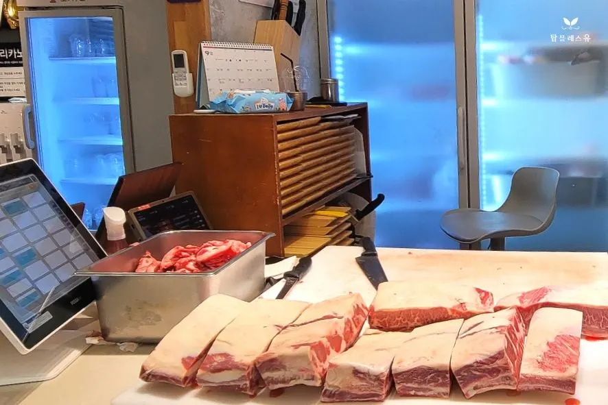 A meat expert trimming beef in the open workspace