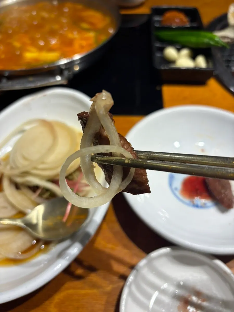 A wrap of beef with side dishes