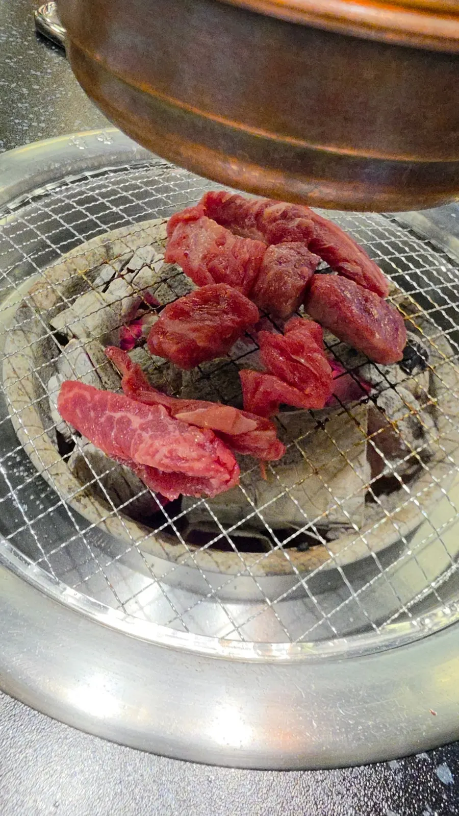Hanwoo flower short rib grilling over charcoal