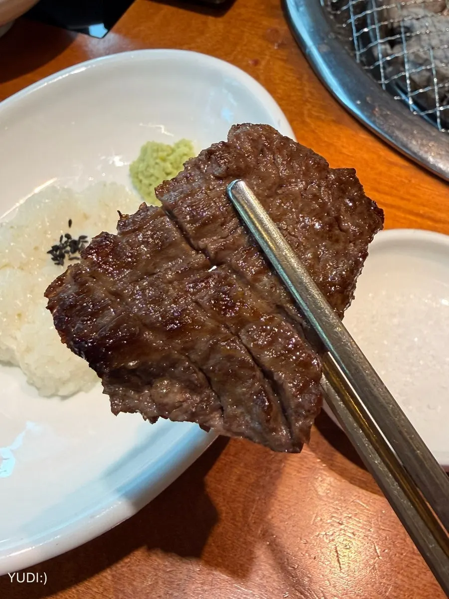 Raw short ribs cooking on the grill