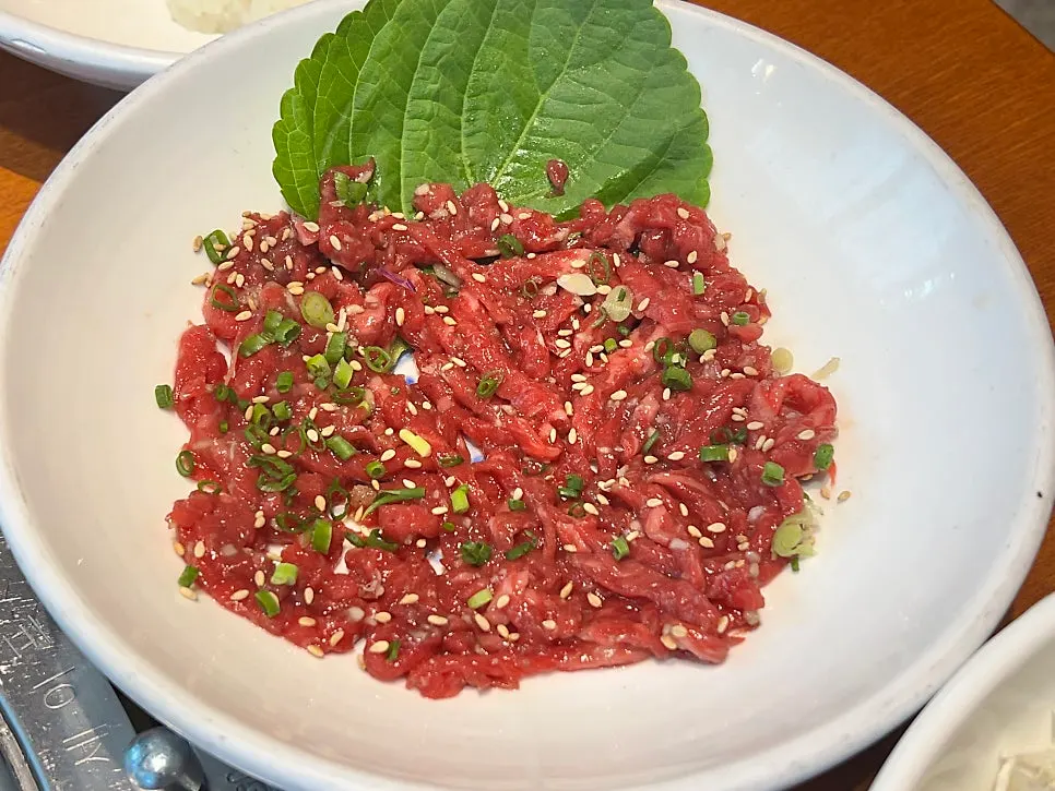 The 9-course set with raw beef, jjolmyeon, sushi rice, and kimchi stew