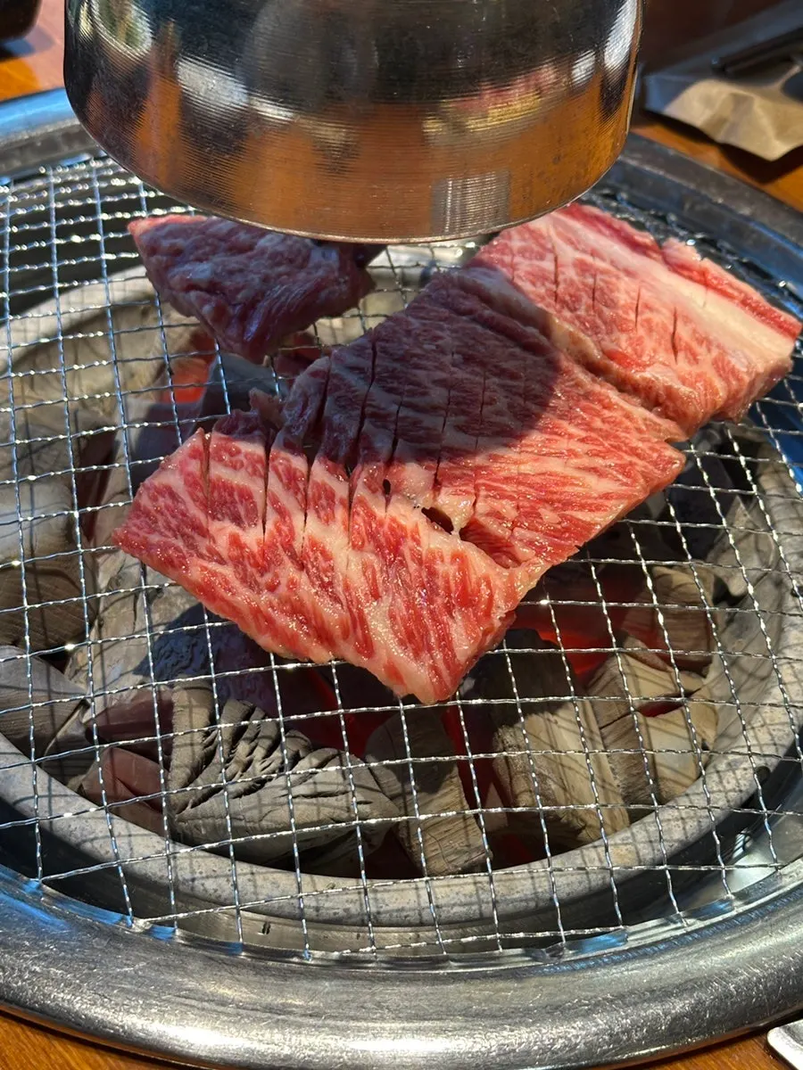Scored raw rib meat on the grill
