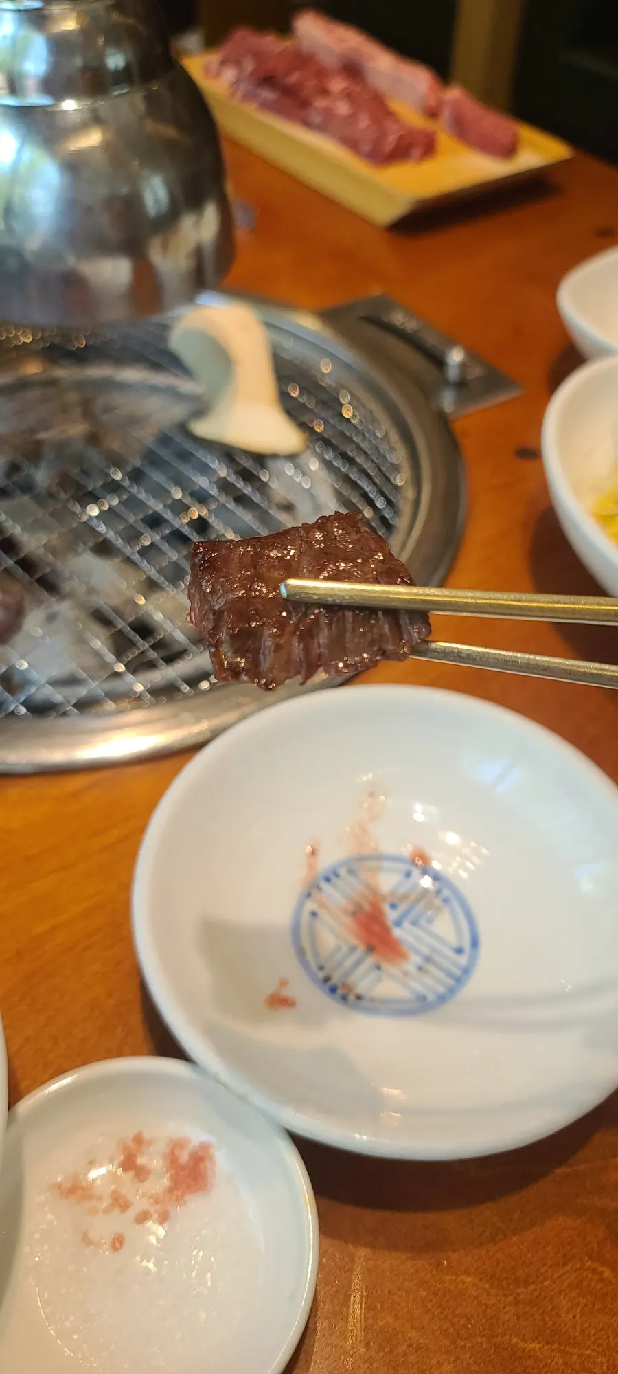 Thick-cut beef grilling over charcoal