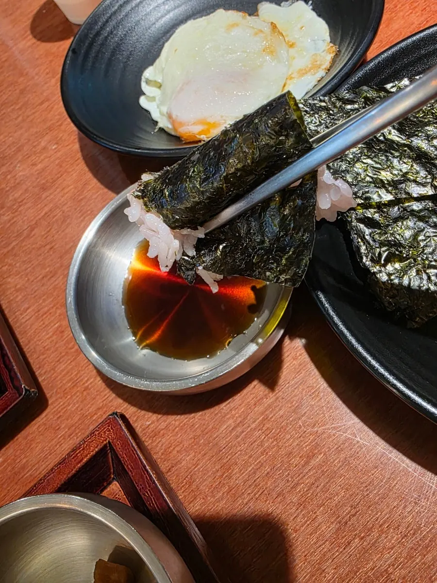 A piece of jjukkumi dipped in mayo sauce