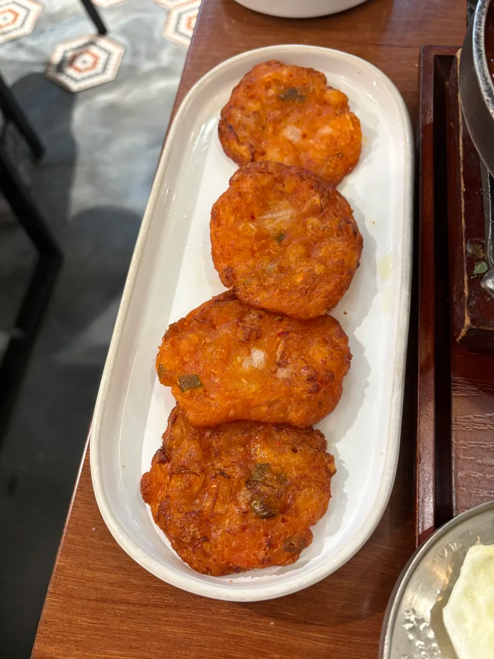 Crispy kimchi jeon served in bite-size pieces