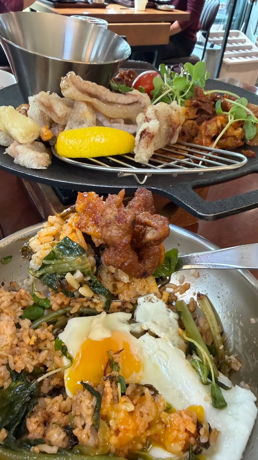 A spoonful of bibimbap topped with jeyuk bokkeum