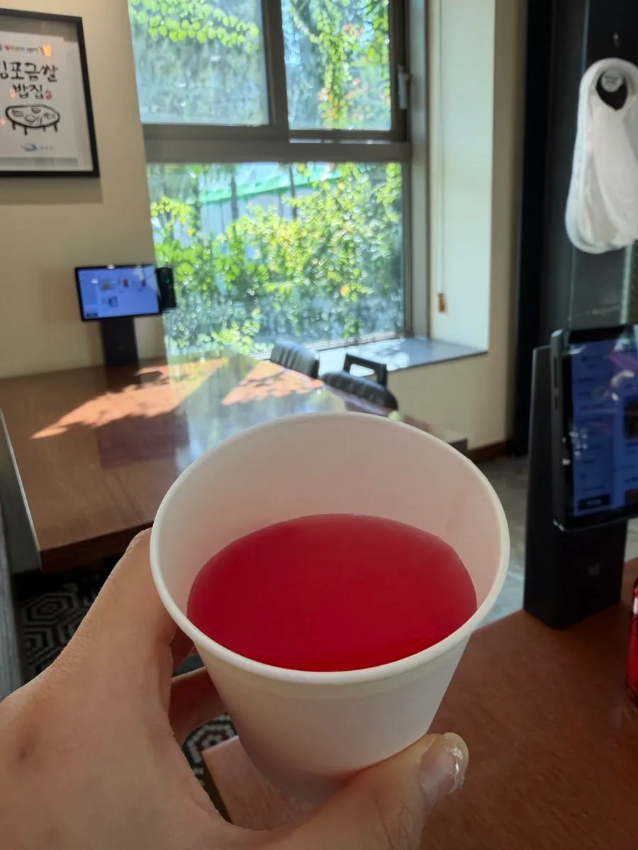 Omija tea poured into a paper cup for dessert