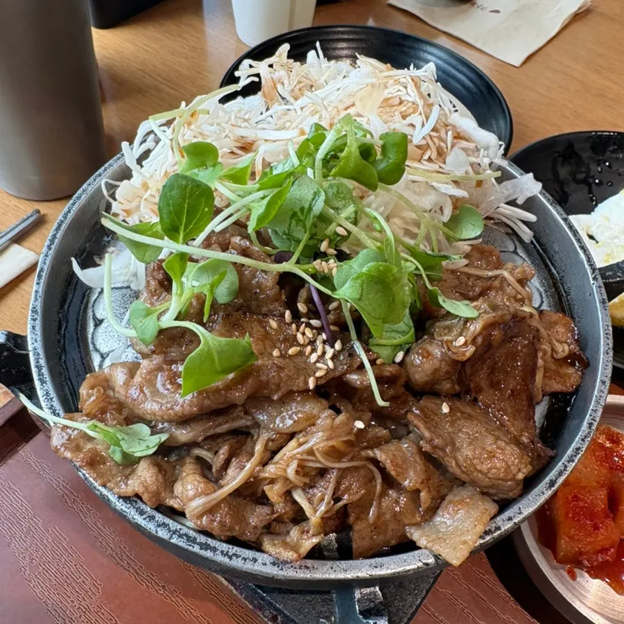 A piece of jeyuk pork on top of warm rice