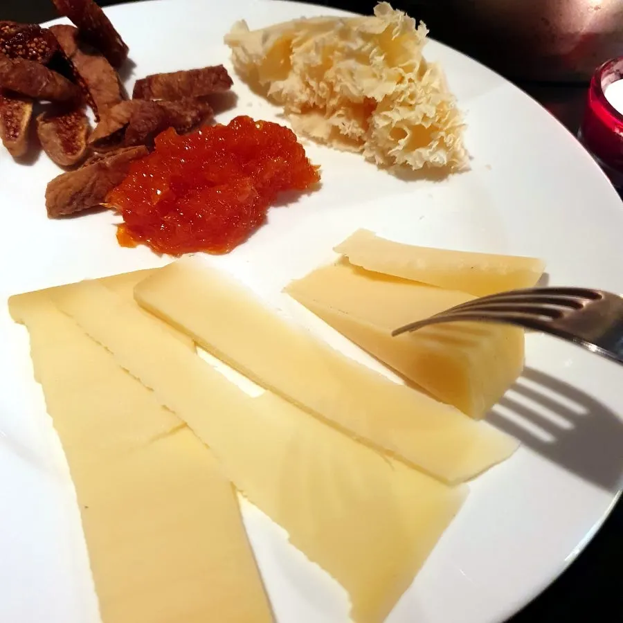 A table at Chin & Nose with wine glasses and a plate