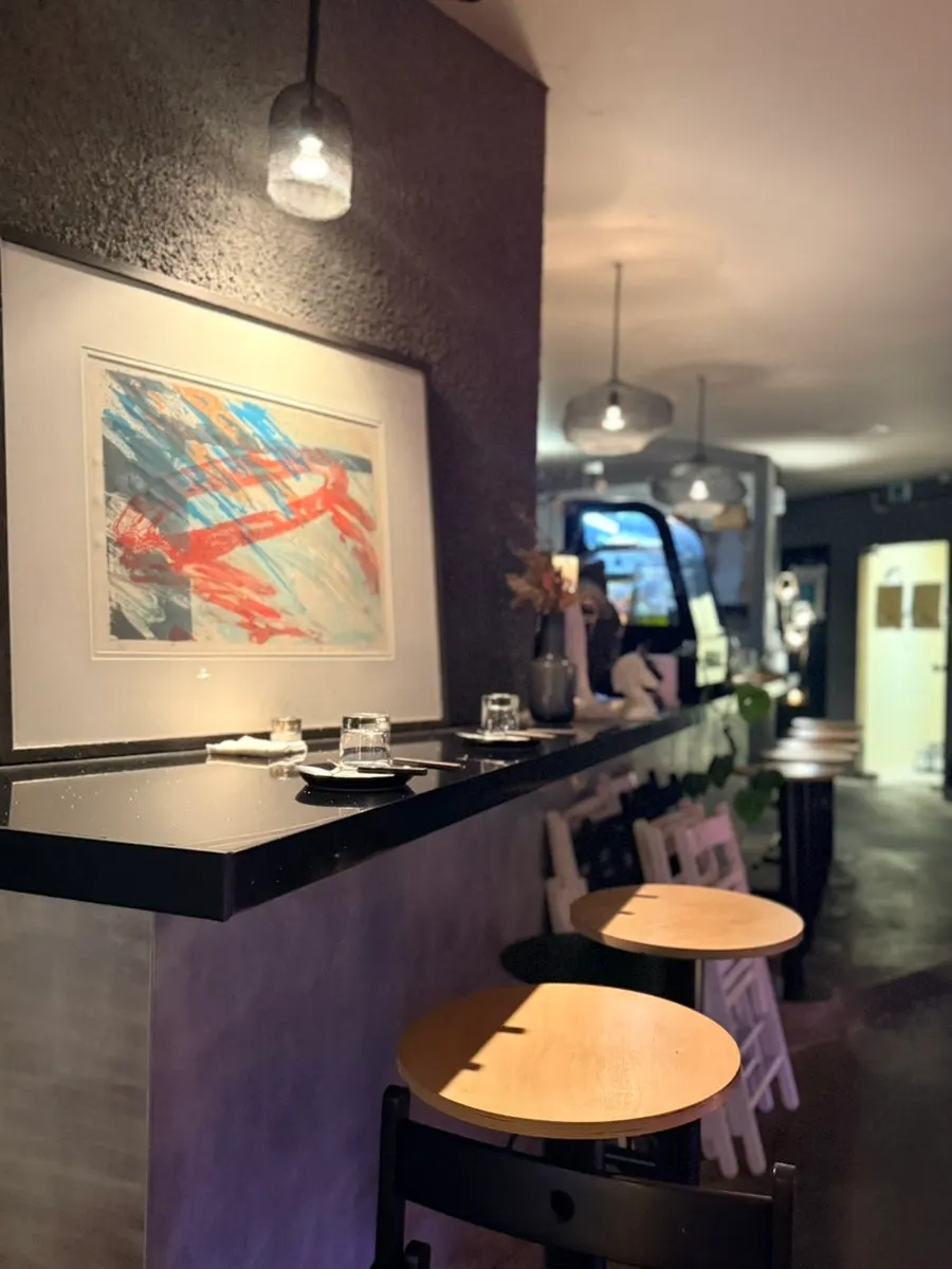 Warmly lit interior of the wine bar with tables set out