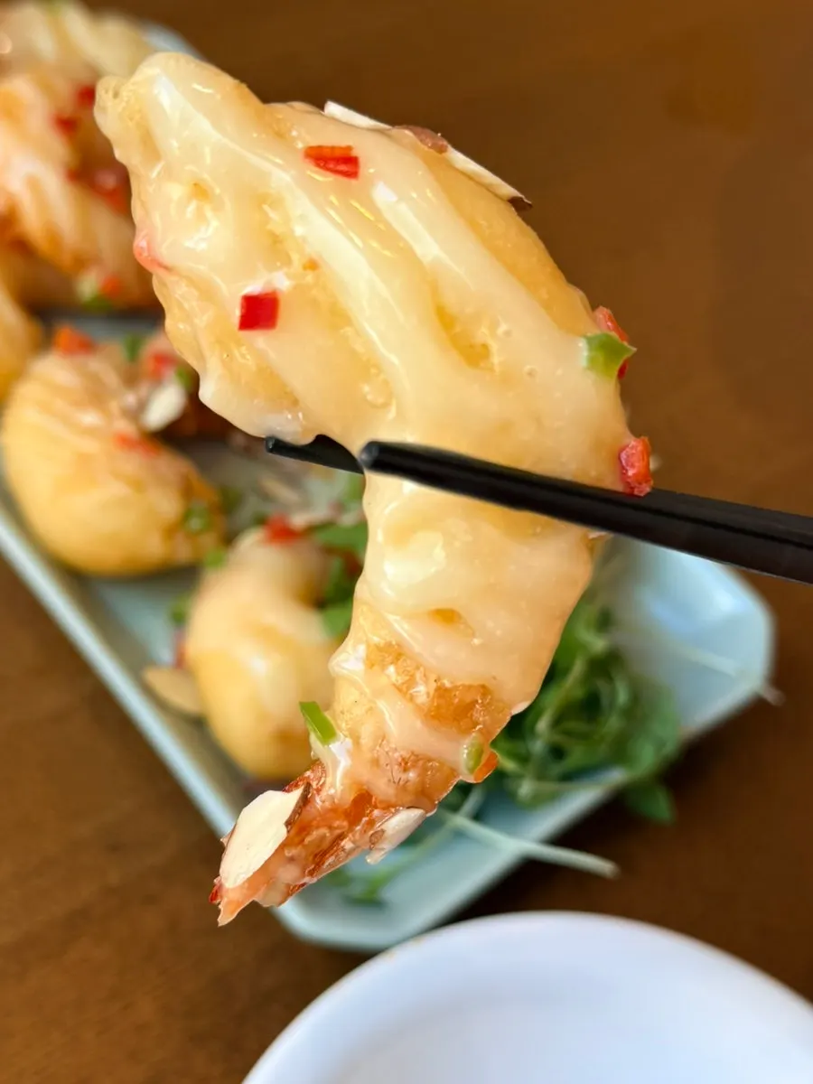 Close-up of crispy cream shrimp topped with cream sauce