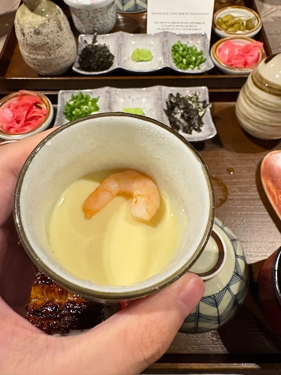 Ochazuke broth with a wooden paddle and empty bowl