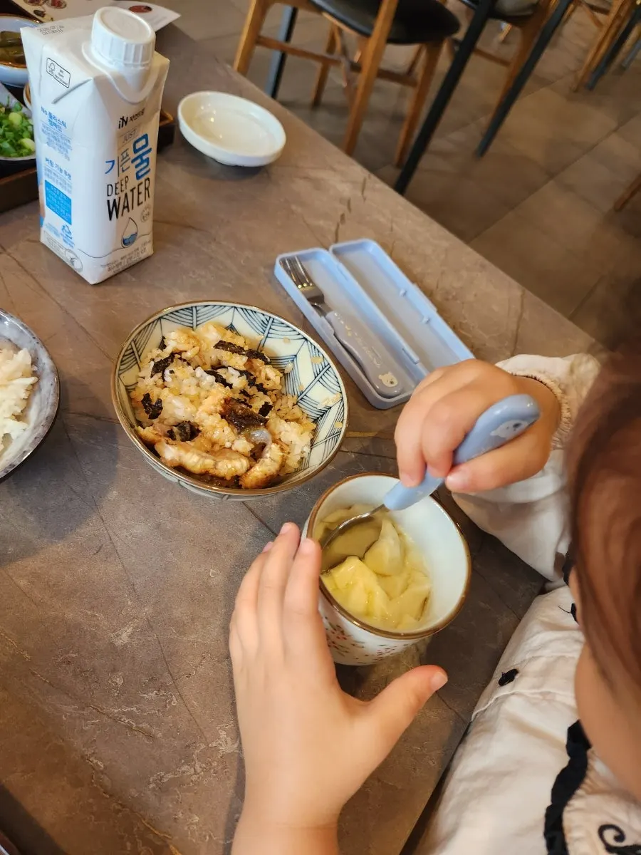 A kid's bowl of rice mixed with seaweed flakes